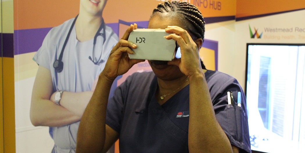 Westmead staff member uses HDR VR cardboard goggles