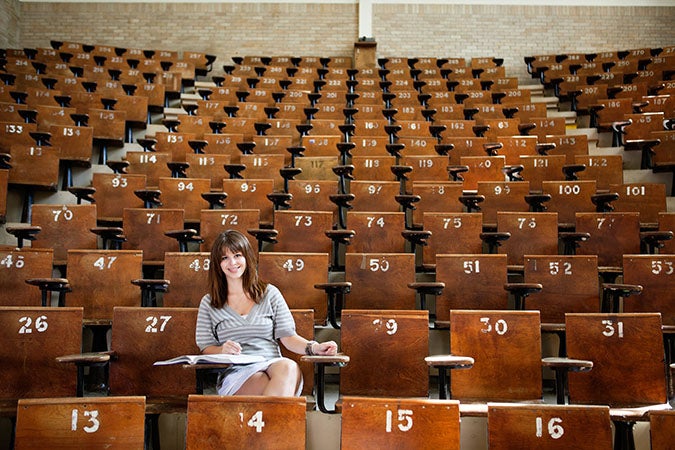 large lecture hall with girl sitting at desk