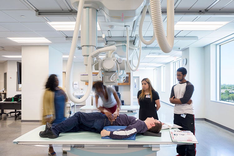 students observing a simulation on the operating room table