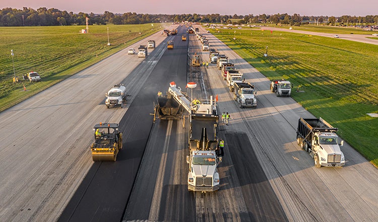 Asphalt trucks on Lexington's Blue Grass Airport runway