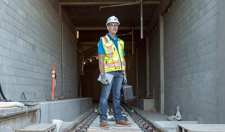 Justin Garrod standing in front of rail tunnel