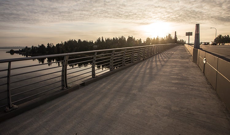 Pedestrian path on the SR 520 bridge at sunset