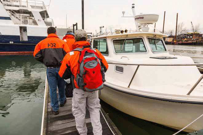 HDR employees getting on an HDR boat to do environmental studies