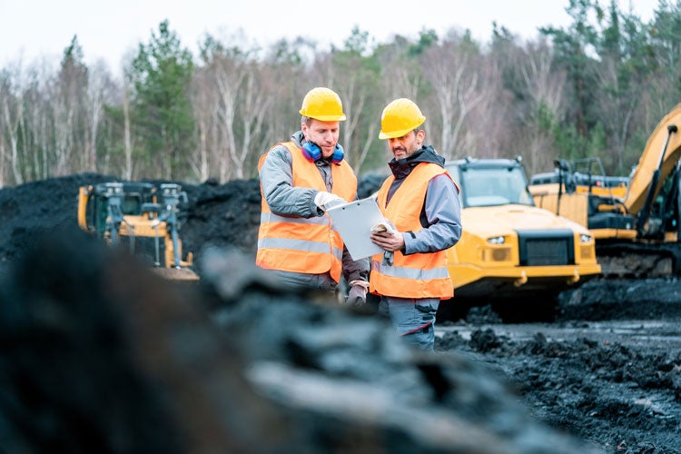 people collaborating at a mine site