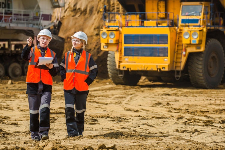 people collaborating at a mine site