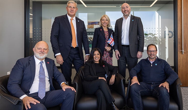 HDR employees from the U.K., U.S. and Australia pose by the British flag