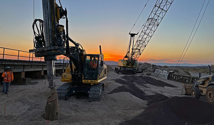 construction vehicles working next to train track