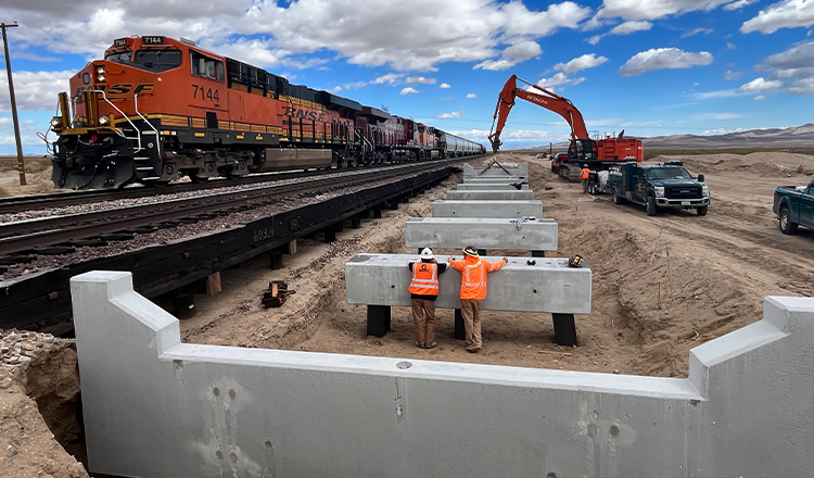 construction vehicles working next to train track