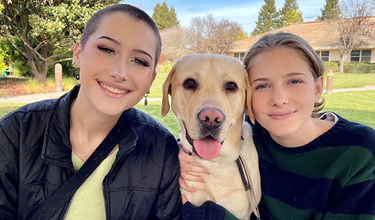 Volunteers with a Canine Companions service dog