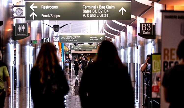 Passengers walk the concourse at the Anchorage airport