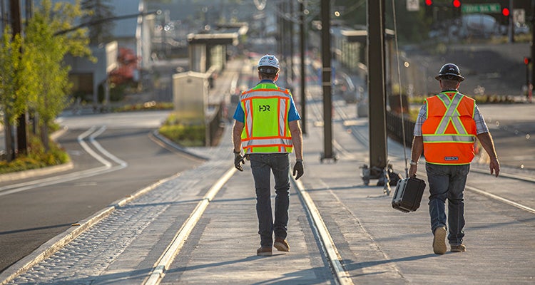 Workers on tracks of East Link Extension project