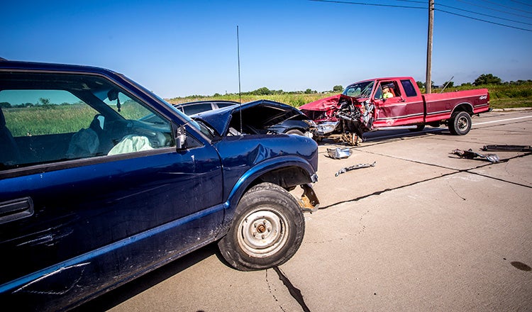 trucks crashed on road with safety dummy in driver's seat