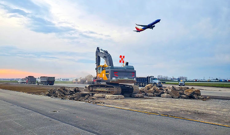 Plane taking off over taxiway construction