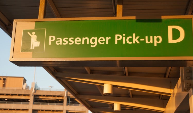 Passenger sign at airport curb
