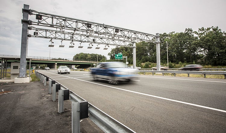 pickup going under toll gantry on interstate