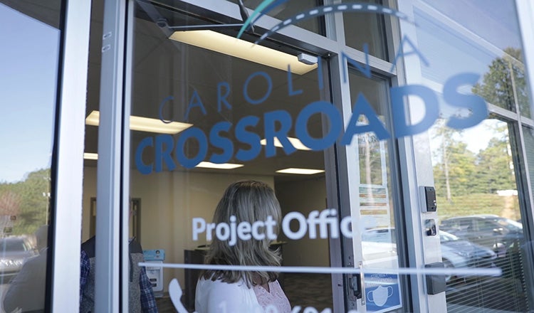 door with text that says Carolina Crossroads project office