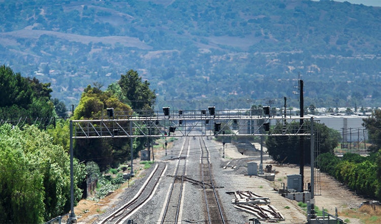 rail tracks extending into distance toward mountain