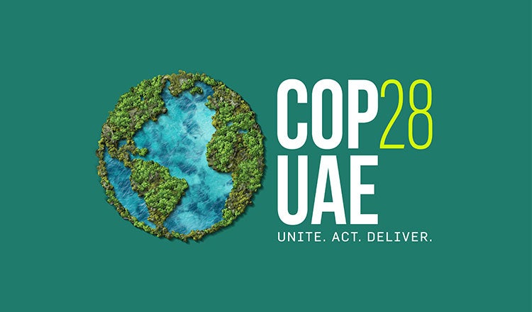Green background with logo for COP28, UAE displayed.