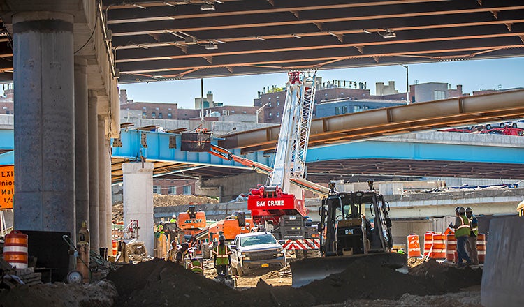 construction workers and vehicles at busy site