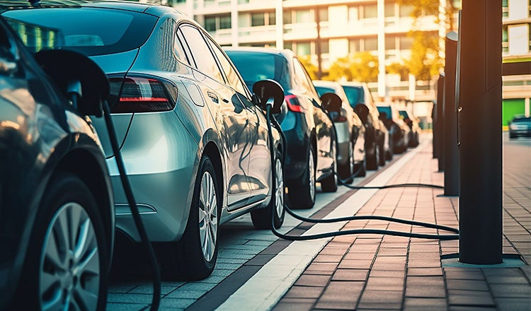 Public parking along the street with charging points for electric vehicles.