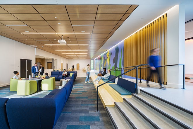 interior common room of Radius Youth Center featuring warm wood tones and bright, yet calming color accents