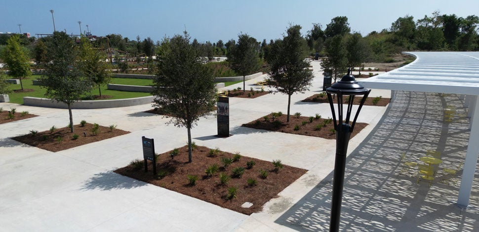 Park with educational signage and an awning that provides shading for seating