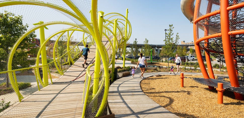 A person running up a bridge on a playground