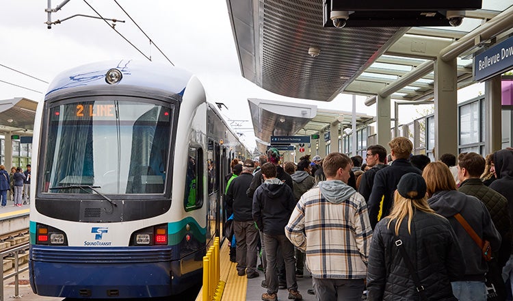 passengers waiting to board train at station