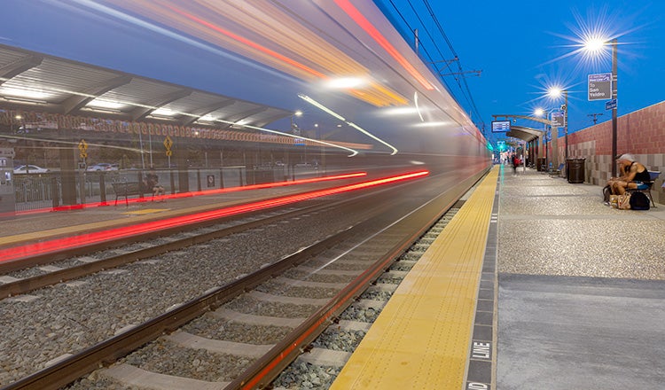 lights of train blurring on tracks