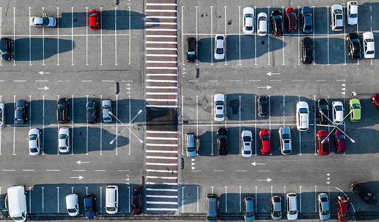cars parked in lot, seen from above