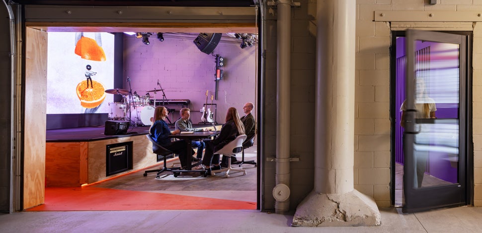 People sitting around a table in a colorful studio space