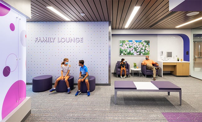 Colorful hospital waiting room, people sitting in the waiting room