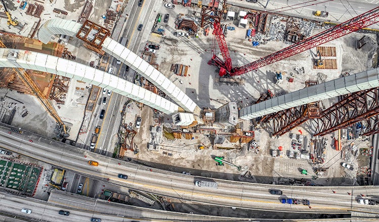 Bridge construction with cars in the background