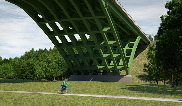bicyclist riding on trail near arched delta frame bridge foundation