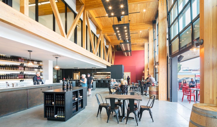 Wine bar with mass timber interiors, people walking around