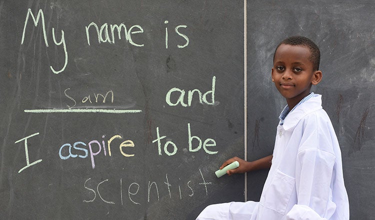 A student by a chalkboard on career day