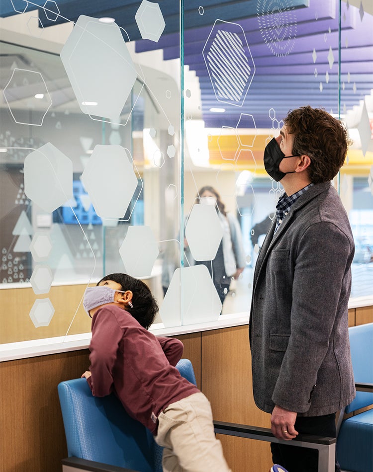 Nebraska Children's Hubbard Center for Children Family Looking at Wayfinding Graphics