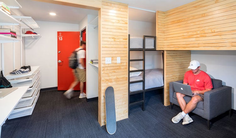 dorm room with bunk beds and wood accents