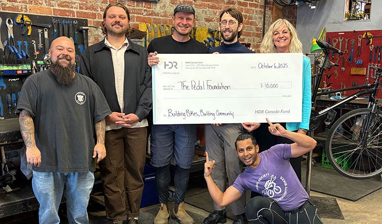 Vancouver, BC, employees present a check to the Pedal Foundation