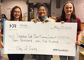 Employees present a check to the Saskatoon Food Bank