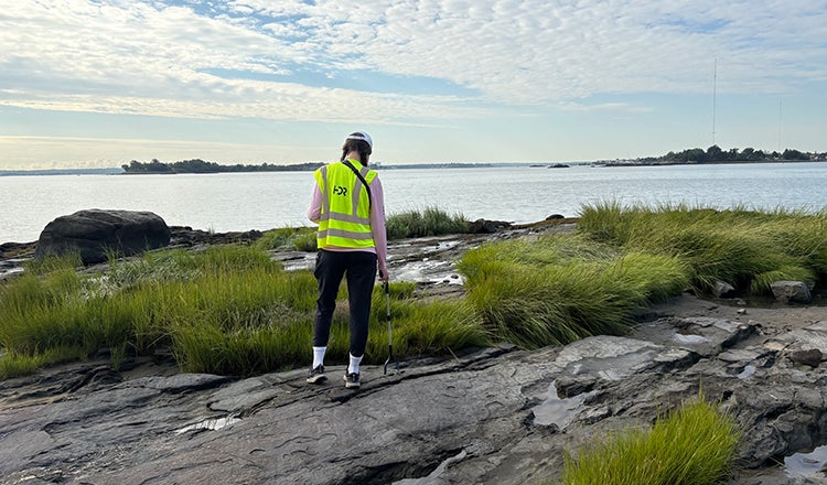 An HDR employee surveys a coastline for the National Litter Study