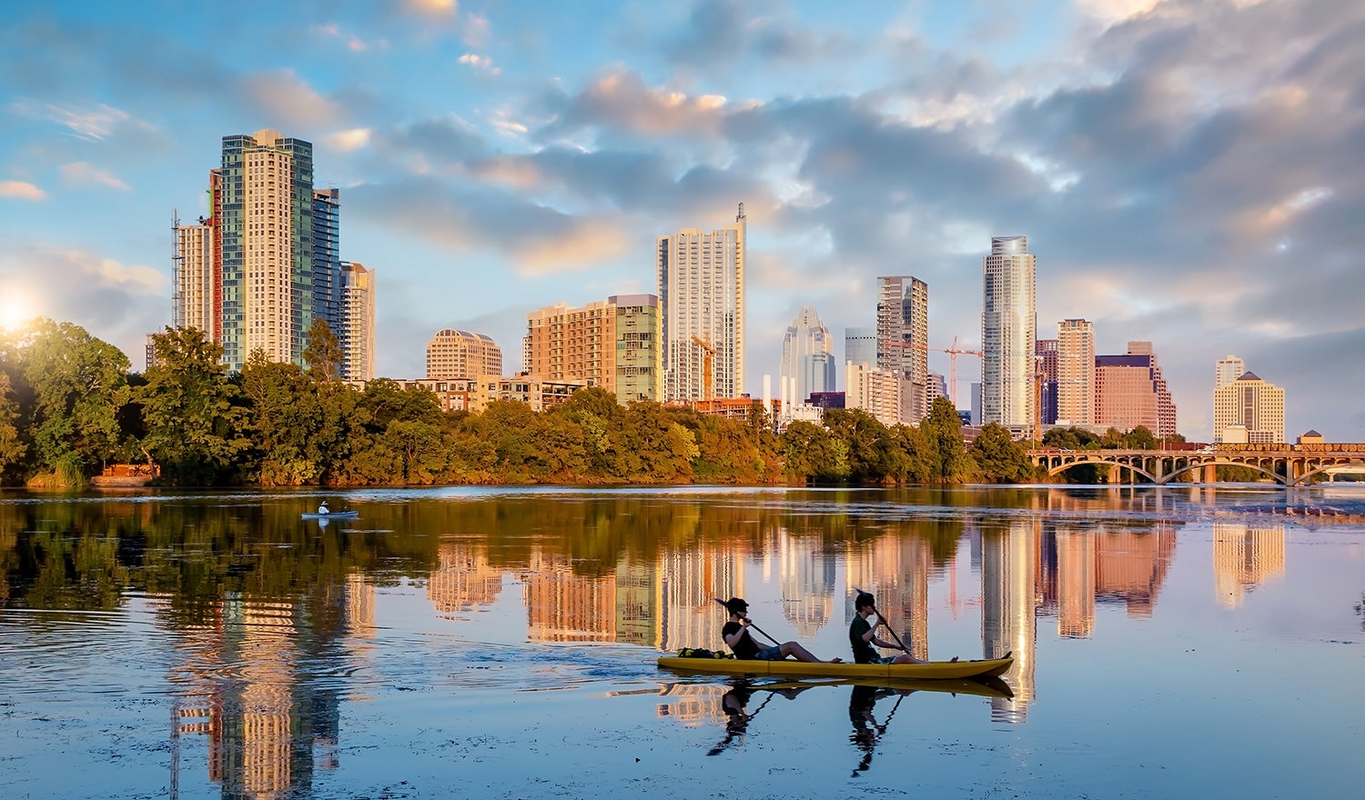 Kayakers floating past the Austin skyline
