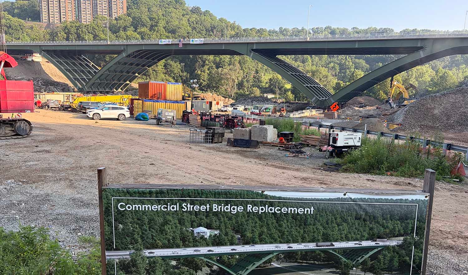arched delta frame bridge with construction equipment