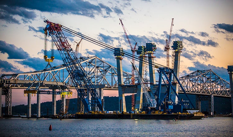 crane on barge during bridge construction