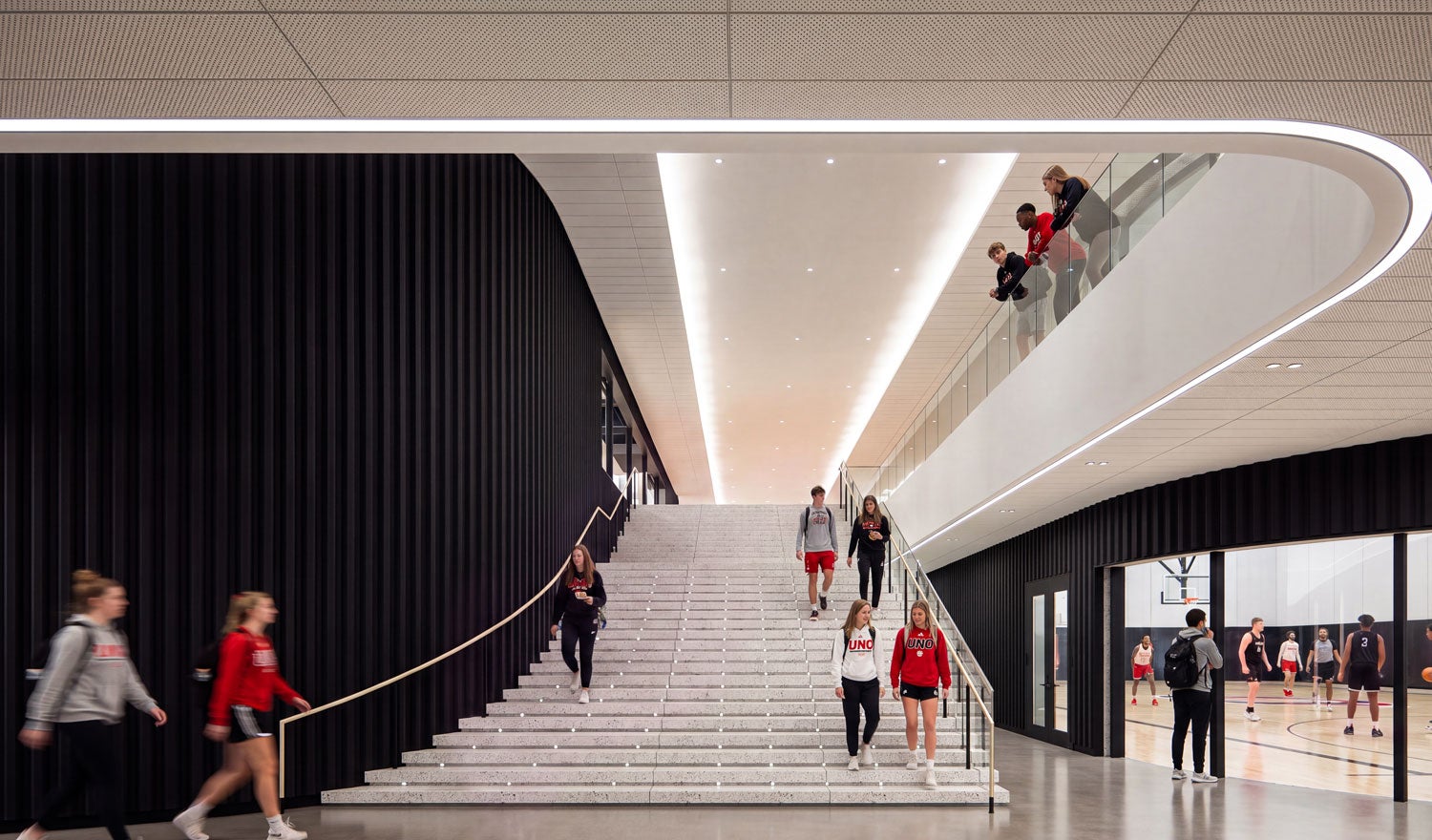 Rendering of students walking down a staircase next to a basketball court