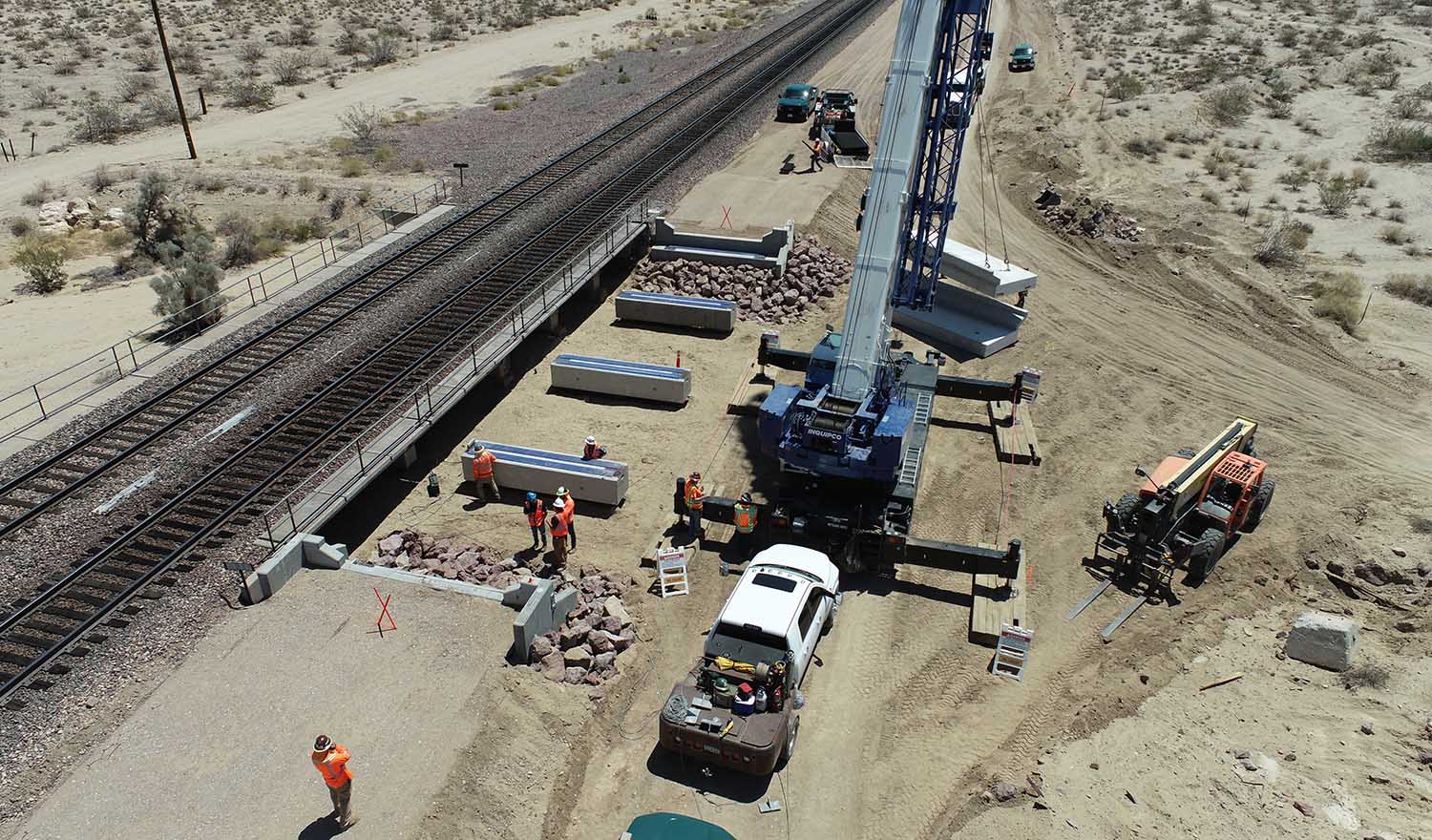 construction equipment by railroad in desert